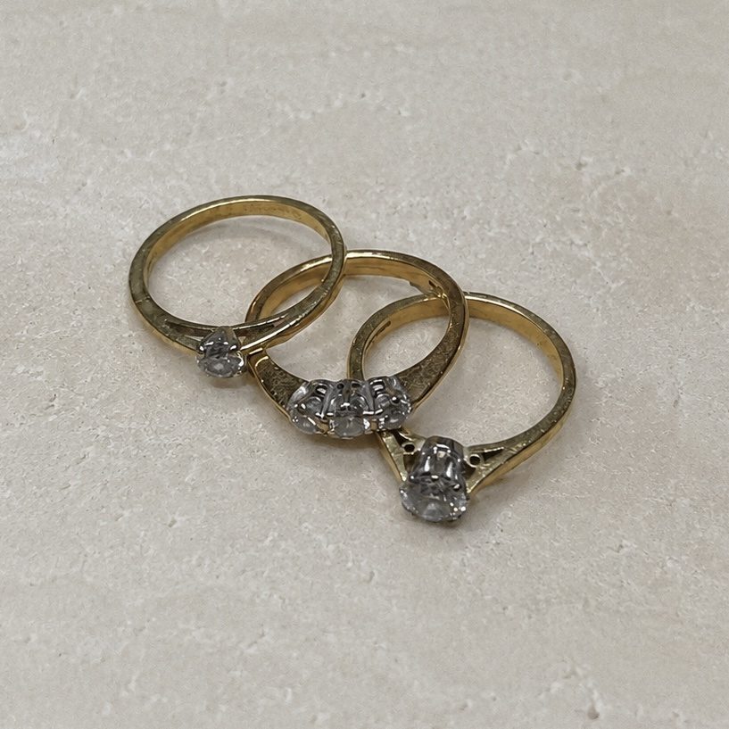 Before — three dated stone-set rings