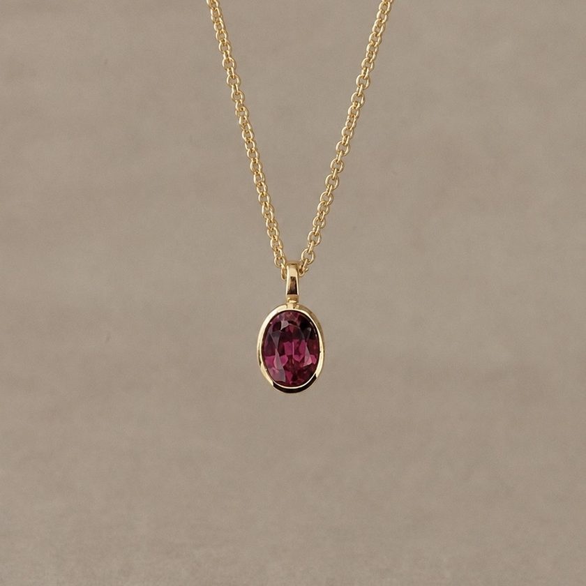 After — the same garnet, remade by Maisie into an everyday pendant