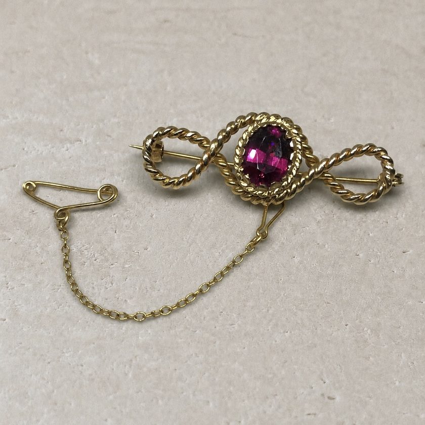 Before — a dated garnet brooch